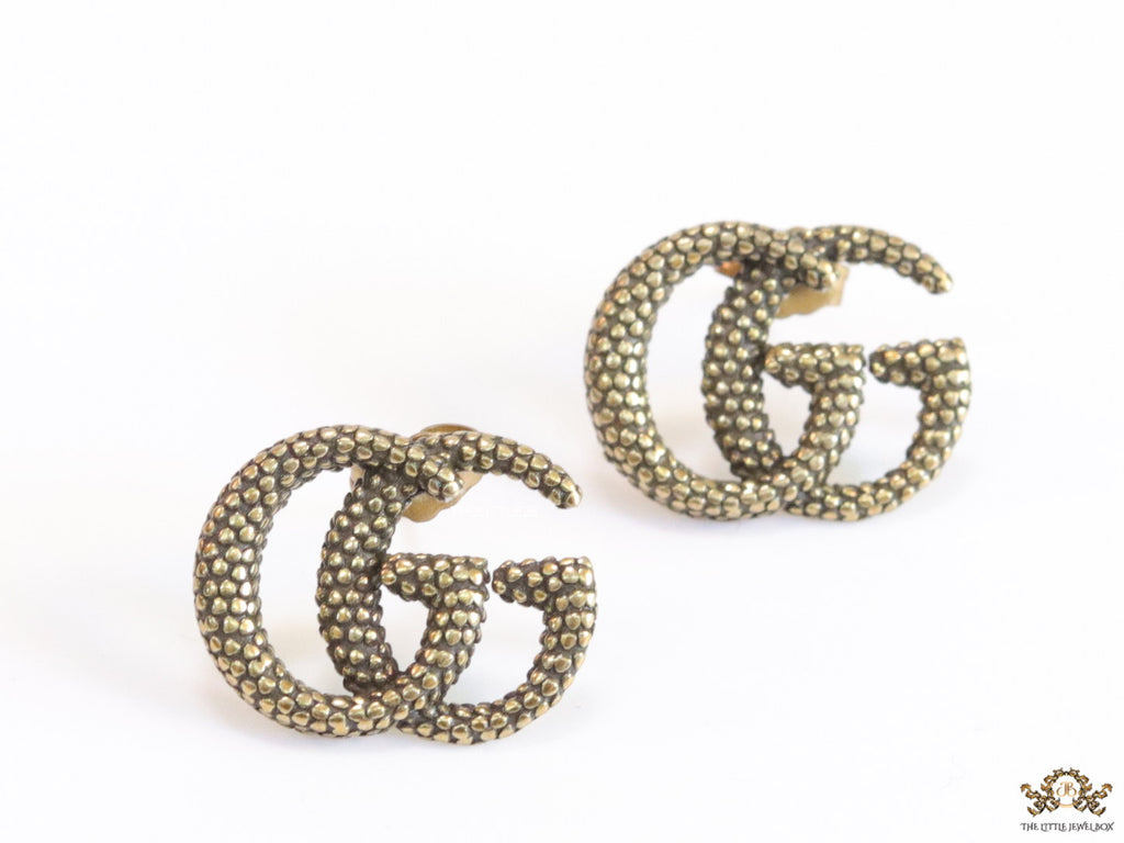 Antique gold plated double G motif studs with honey comb texture