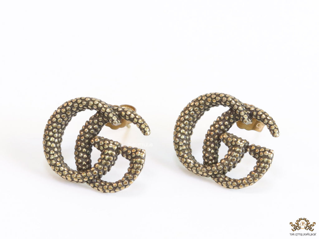 Antique gold plated double G motif studs with honey comb texture