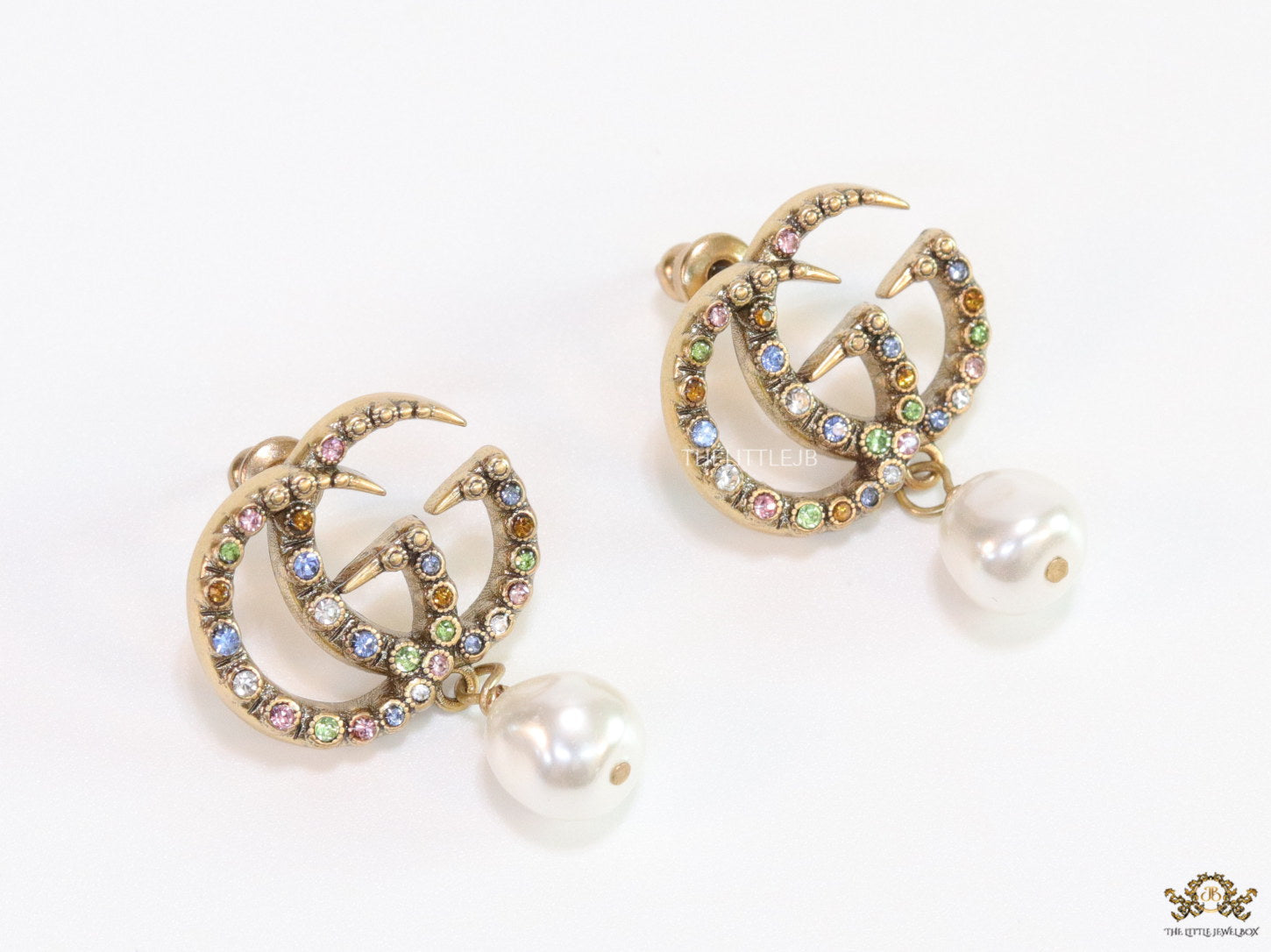 Double G golden earrings with multi color cz stones and pearl