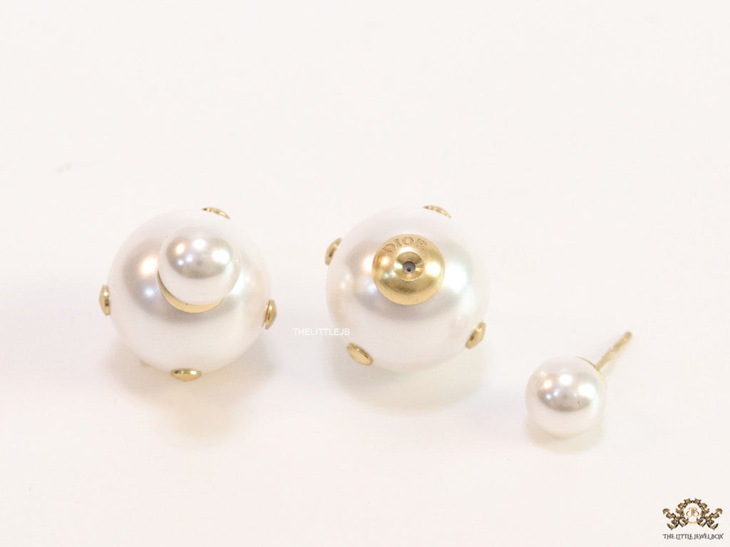 White pearl studs with golden alphabet motif and golden details