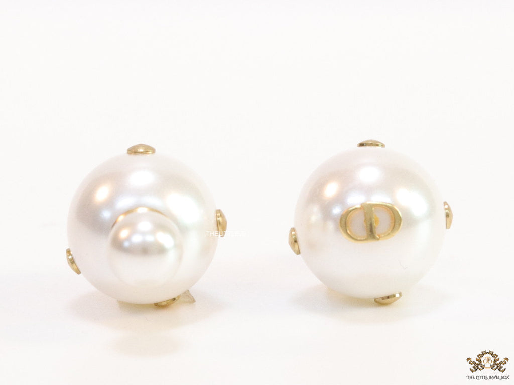 White pearl studs with golden alphabet motif and golden details