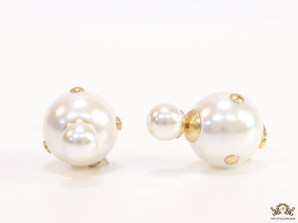 White pearl studs with golden alphabet motif and golden details