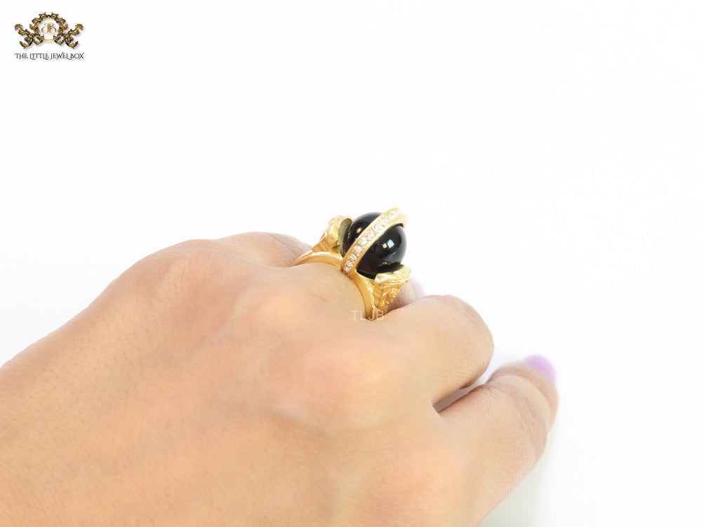 Double gold Medusa with CZ on black ball ring