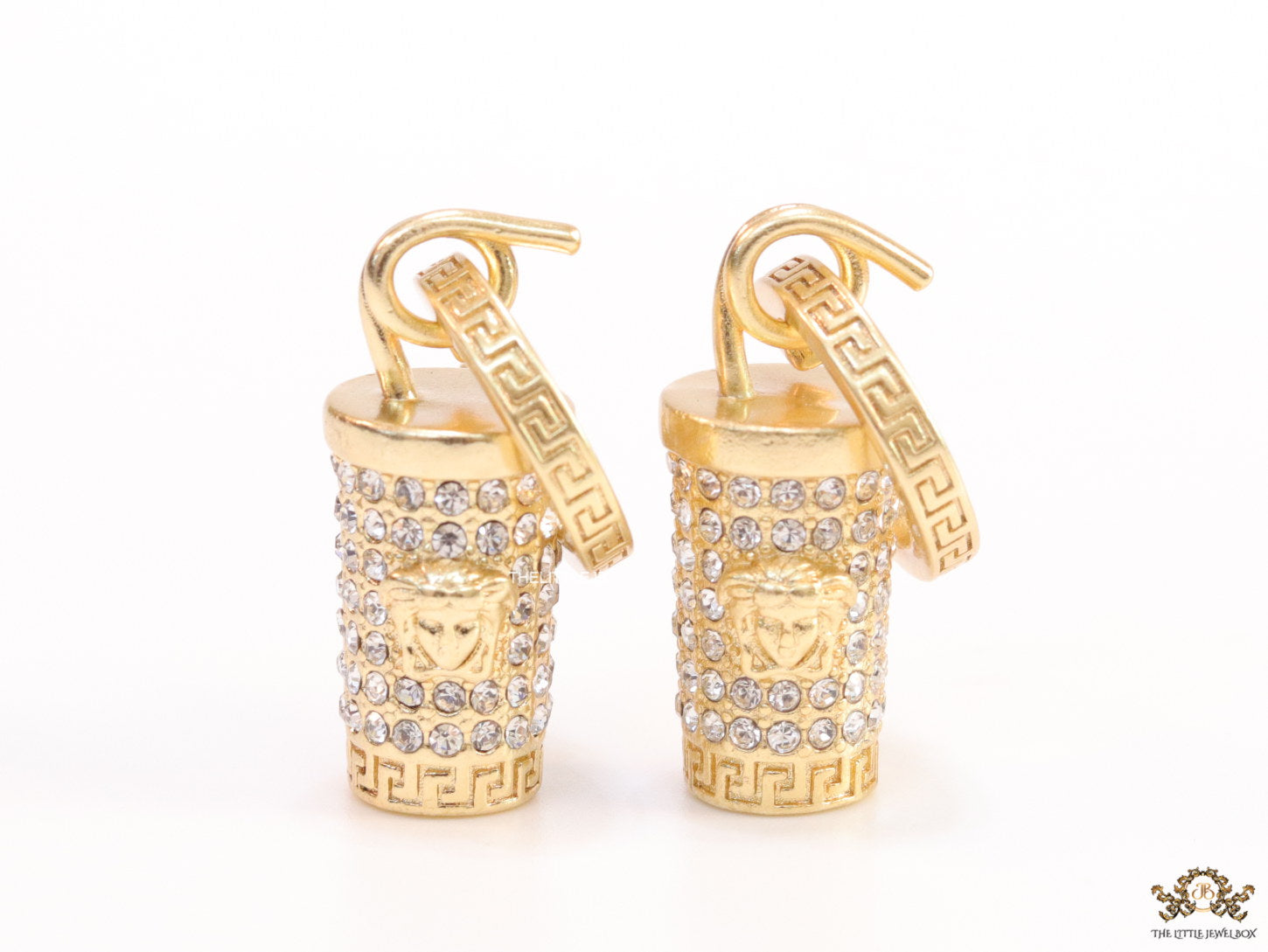 Gold plated hoop with cubic zirconia and 3d golden Medusa motif on cylidrical drop.