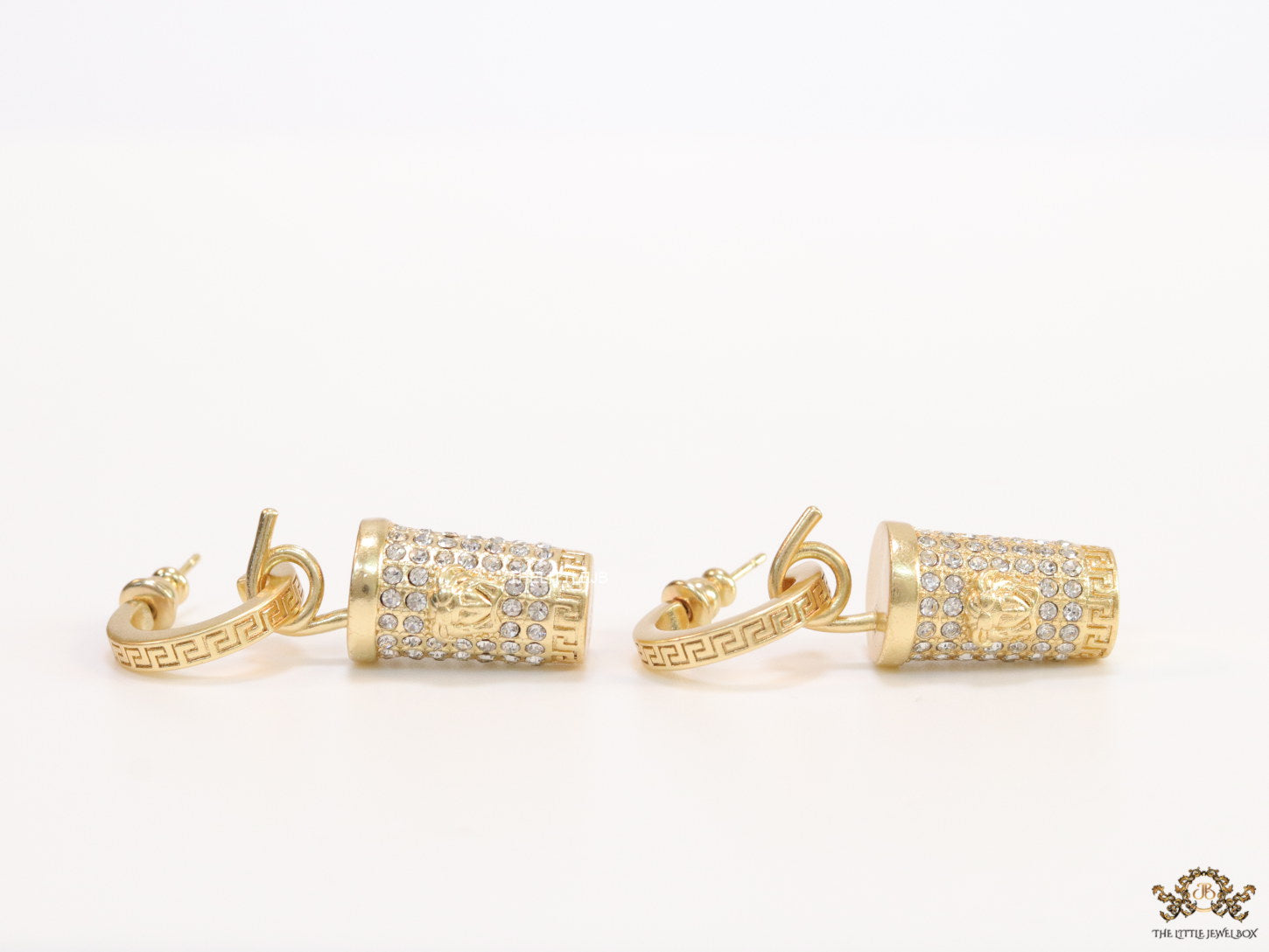 Gold plated hoop with cubic zirconia and 3d golden Medusa motif on cylidrical drop.