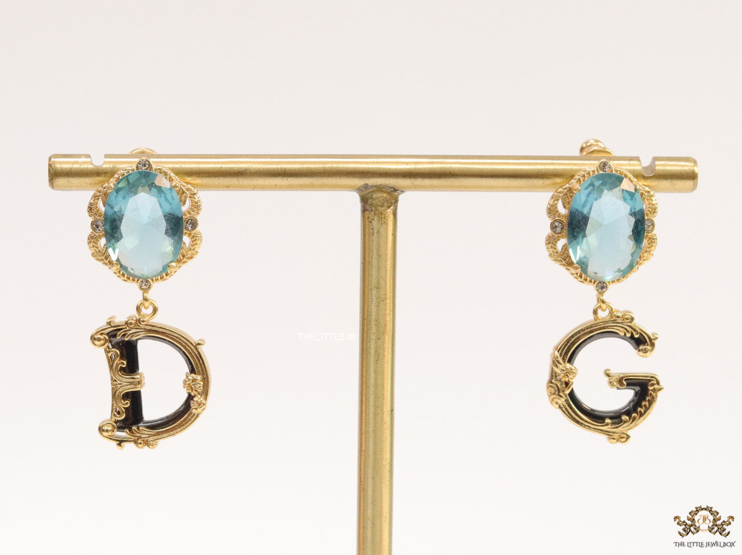 Semi-precious blue stone with gold plated detailed with black and golden alphabet drop