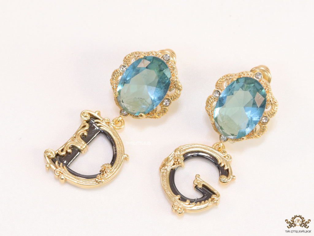 Semi-precious blue stone with gold plated detailed with black and golden alphabet drop