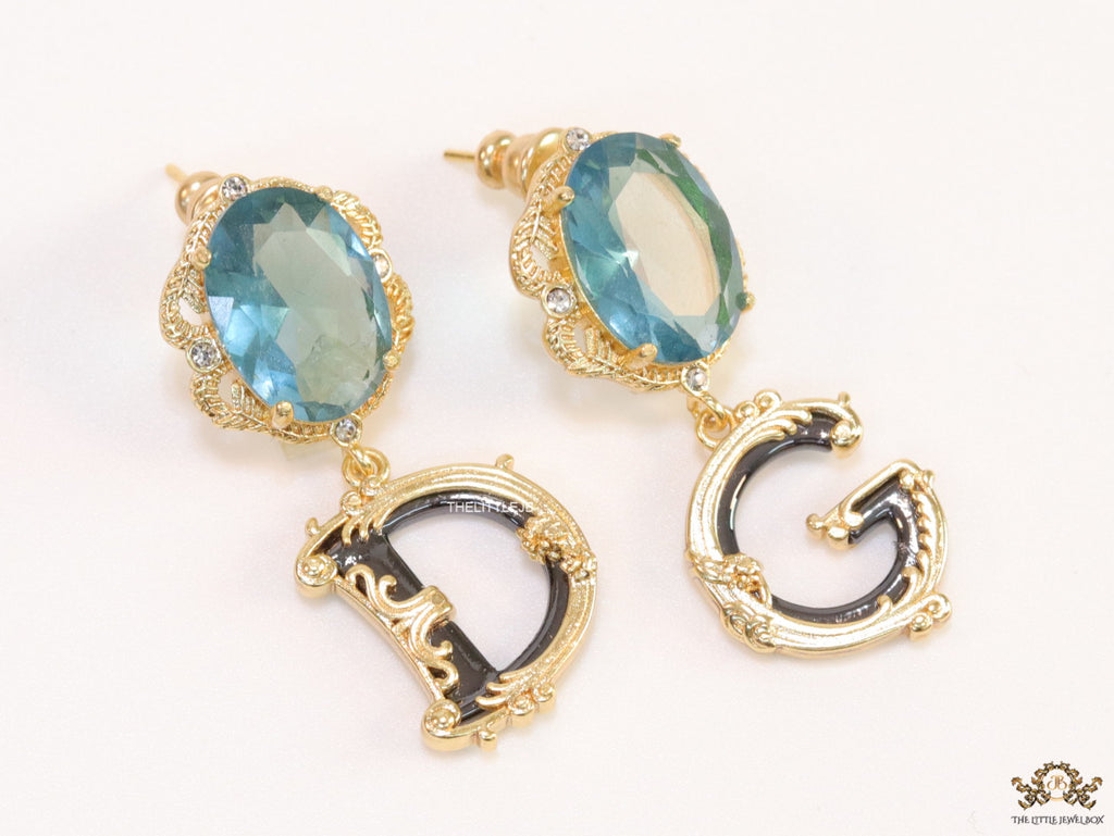 Semi-precious blue stone with gold plated detailed with black and golden alphabet drop