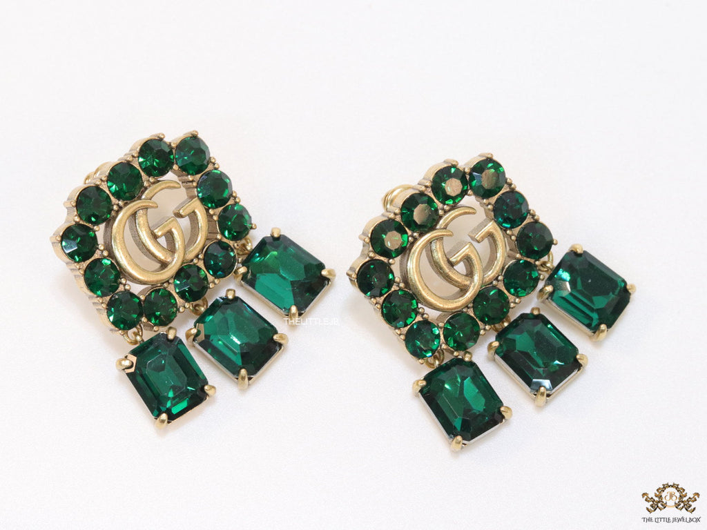 Emerald Green stone studs with gold plated double G motif and emerald green stone drop
