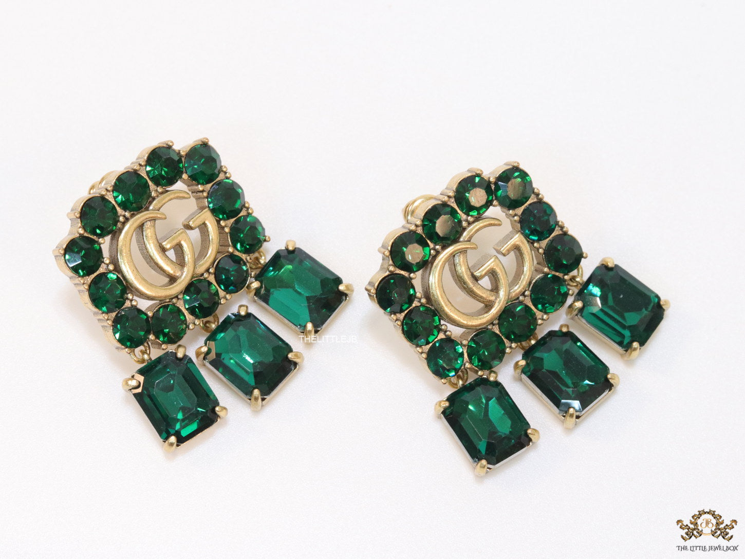 Emerald Green stone studs with gold plated double G motif and emerald green stone drop