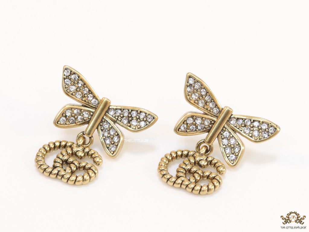 Studed cubic zirconia stone butterfly studs with textured double G motif drop