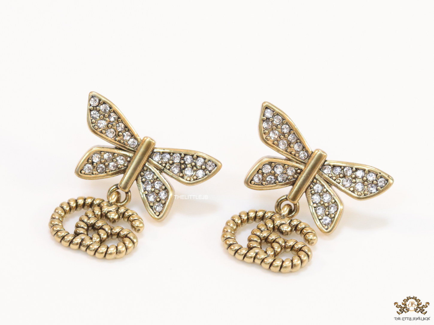 Studed cubic zirconia stone butterfly studs with textured double G motif drop