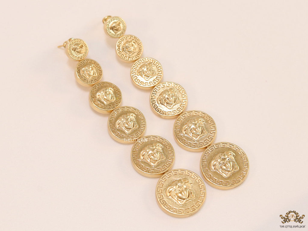 Gold plated embossed Medusa motif on golden circular base with golden details long chain studs