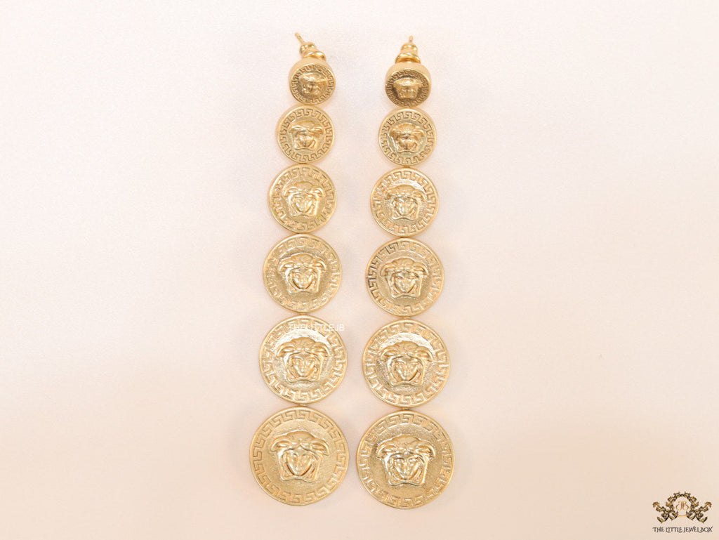Gold plated embossed Medusa motif on golden circular base with golden details long chain studs
