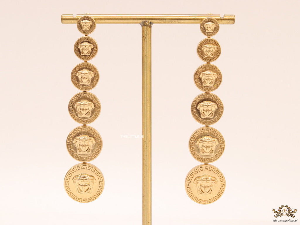 Gold plated embossed Medusa motif on golden circular base with golden details long chain studs