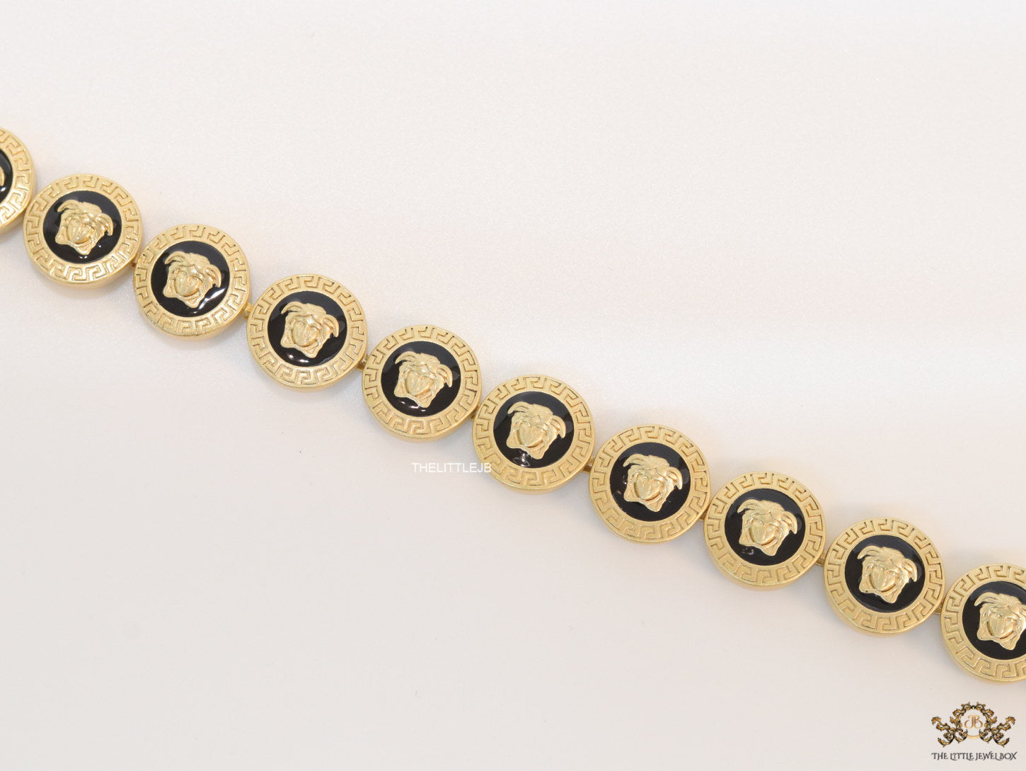 Gold plated Medusa motif on black circles necklace