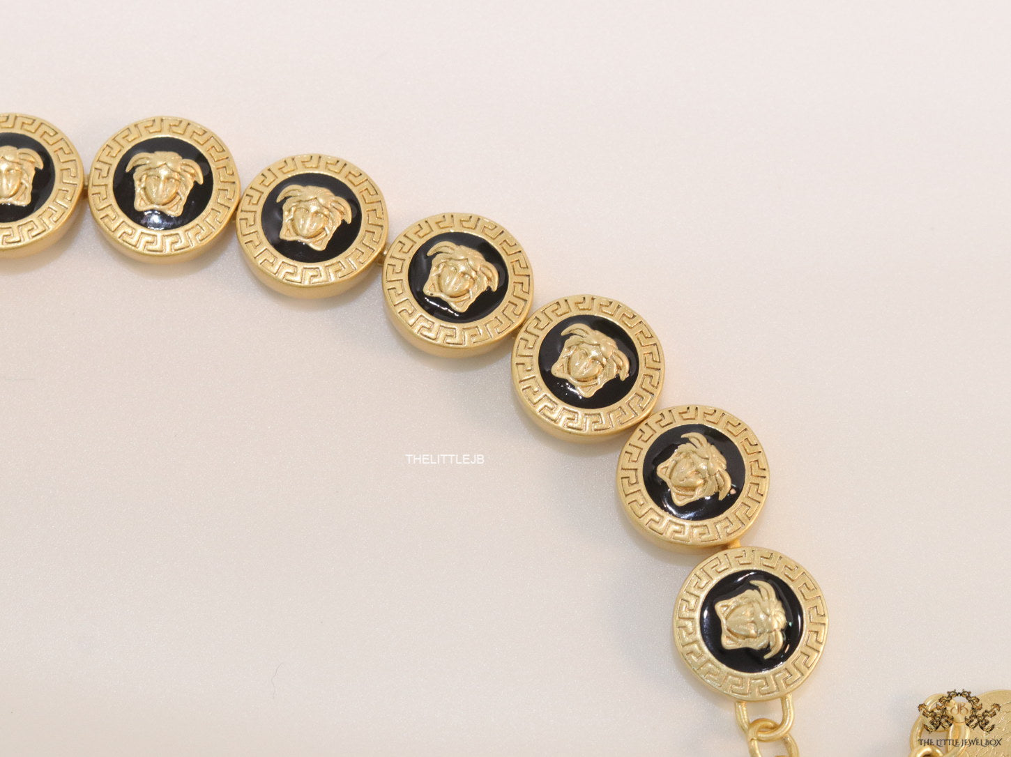 Gold plated Medusa motif on black circles necklace