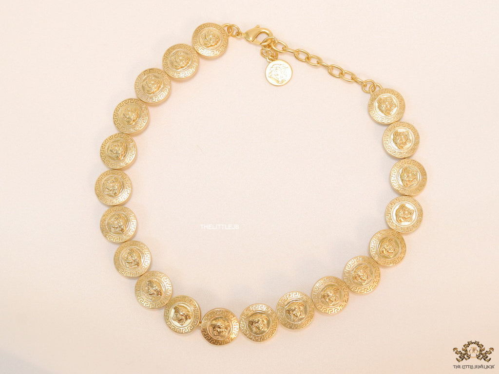 Gold plated embossed Medusa motif on gold circle base necklace