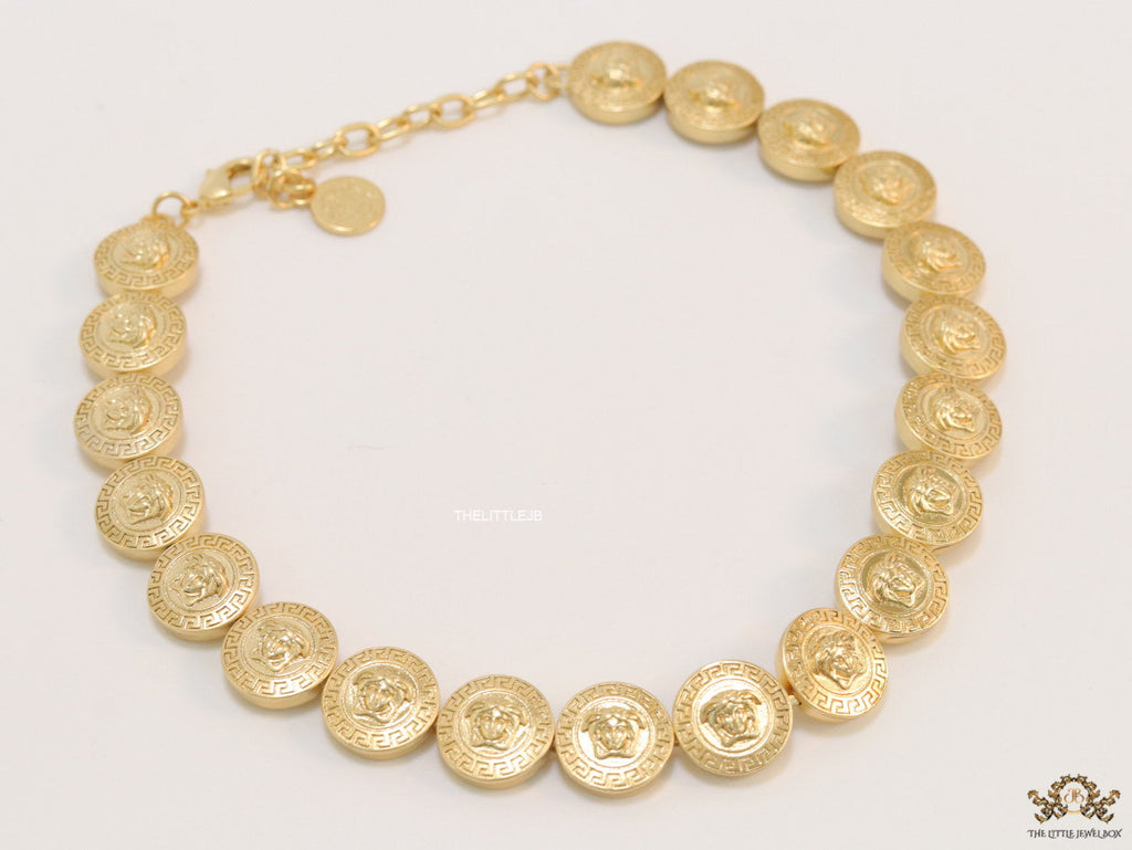 Gold plated embossed Medusa motif on gold circle base necklace