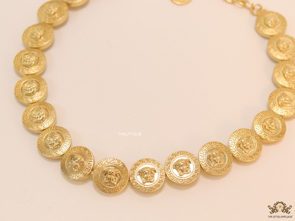 Gold plated embossed Medusa motif on gold circle base necklace