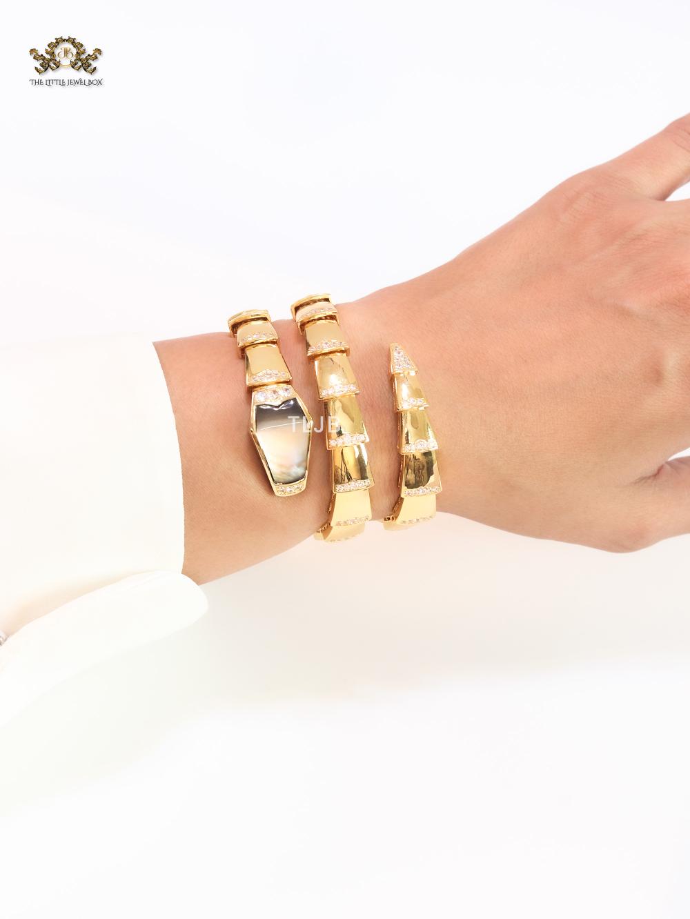 Bold gold and cz snake bracelet with black mop head