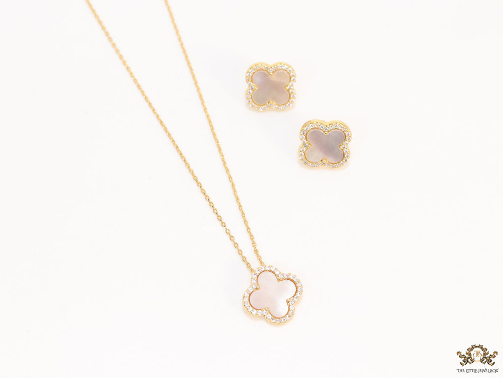 Sleek gold plated chain with cubic zirconia studded off-white clover shape pendant