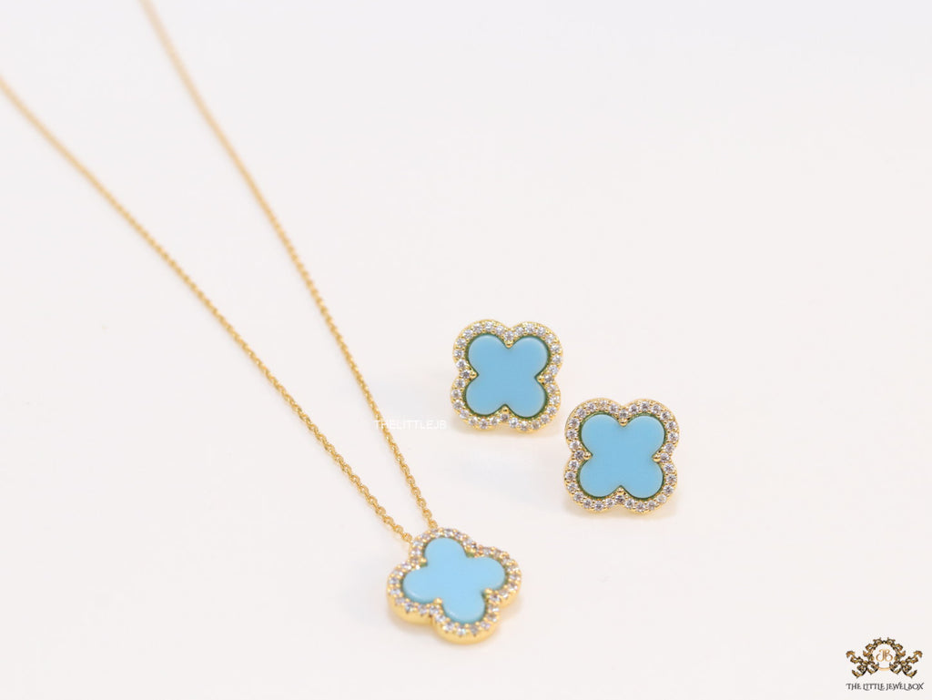 Sleek gold plated chain with cubic zirconia studded blue clover shape pendant
