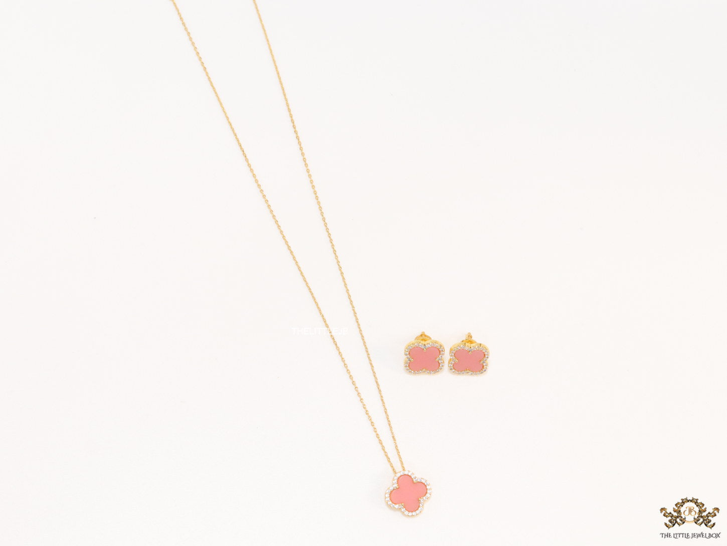 Sleek gold plated chain with cubic zirconia studded pink clover shape pendant