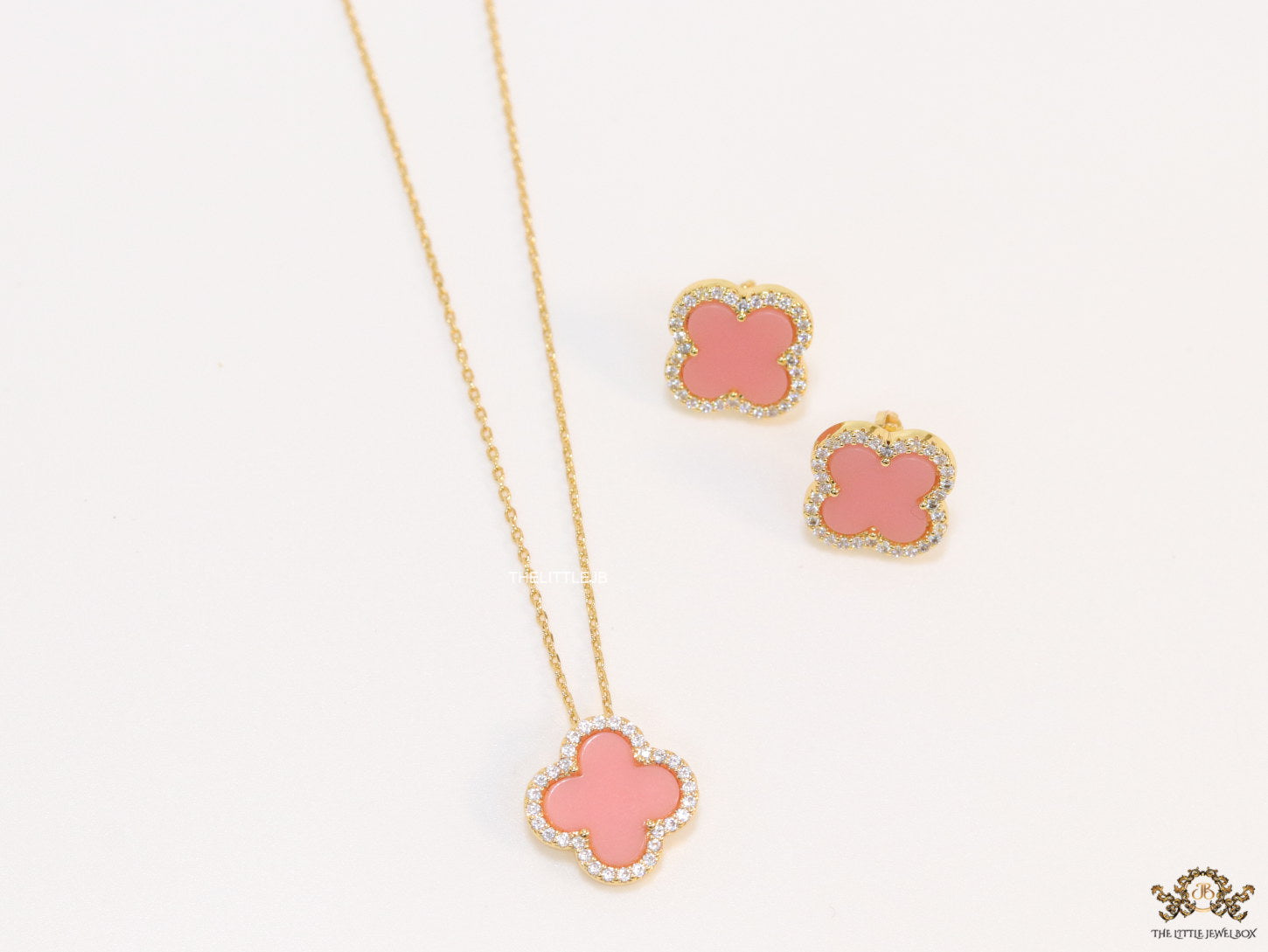 Sleek gold plated chain with cubic zirconia studded pink clover shape pendant