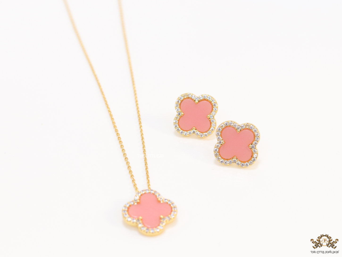 Sleek gold plated chain with cubic zirconia studded pink clover shape pendant