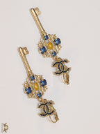 Gold plated key earrings with double C motif and clovers