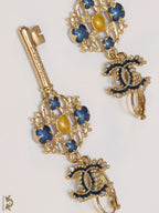 Gold plated key earrings with double C motif and clovers