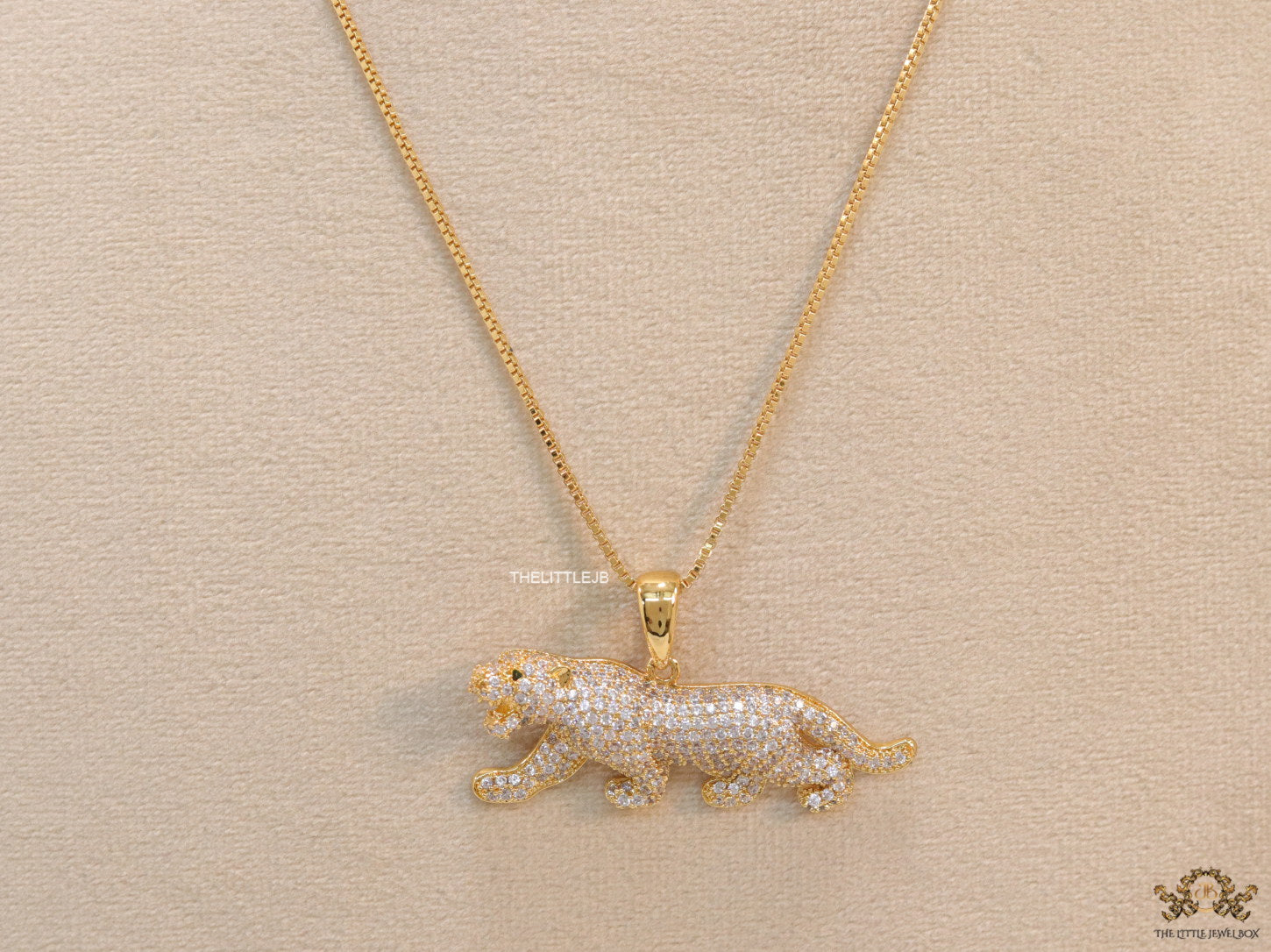 Gold plated cubic zirconia panther pendant on sleek gold plated chain
