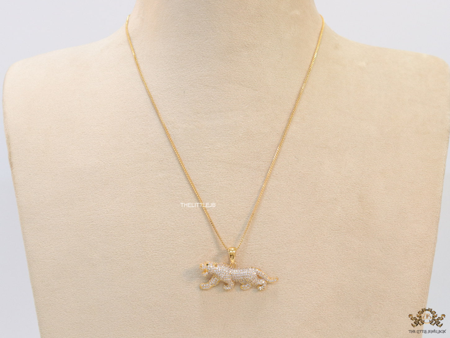 Gold plated cubic zirconia panther pendant on sleek gold plated chain