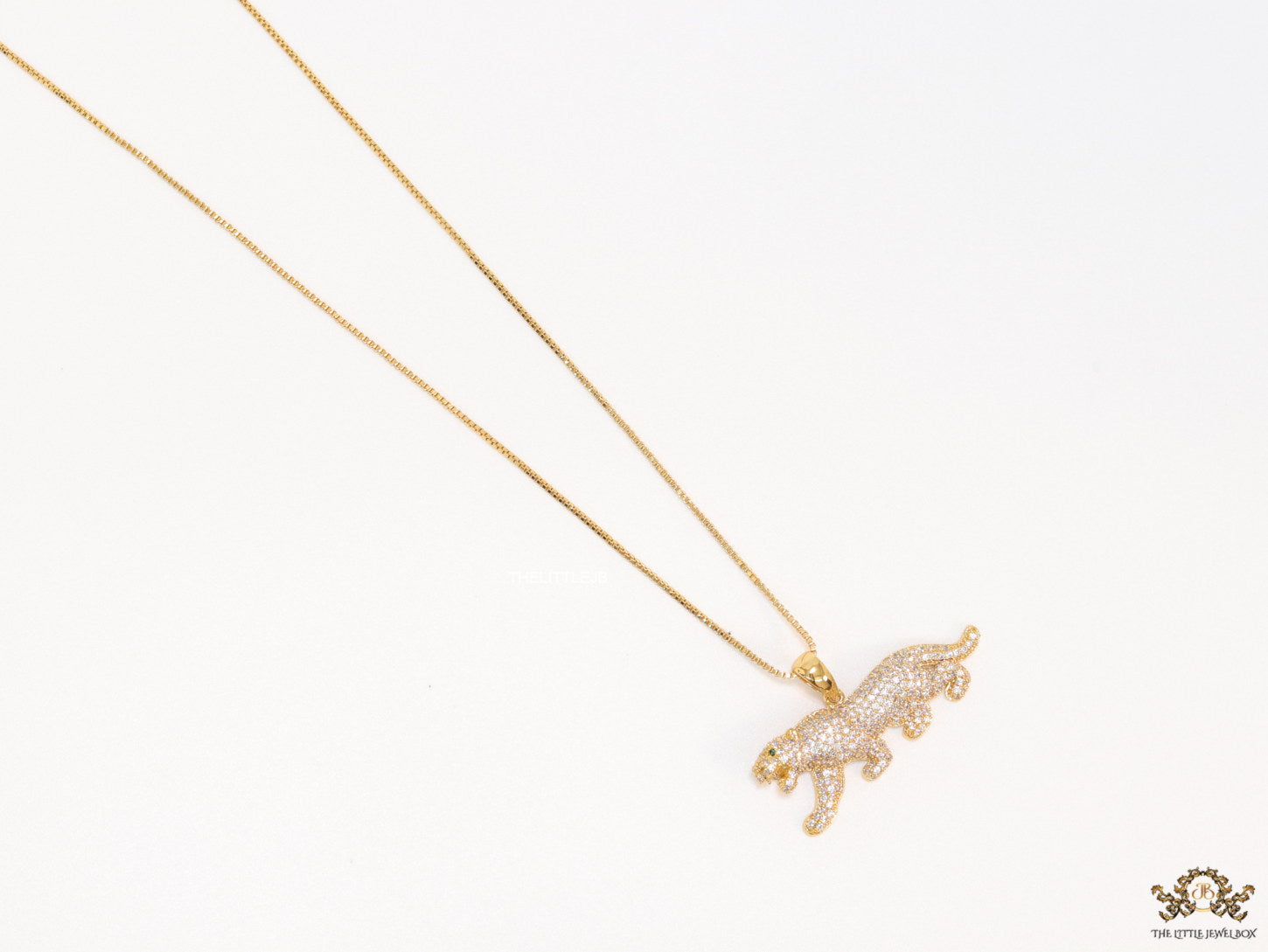 Gold plated cubic zirconia panther pendant on sleek gold plated chain