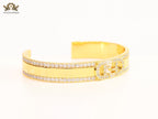 Double F on gold bracelet with cz