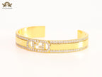 Double F on gold bracelet with cz