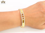Double F on gold bracelet with cz