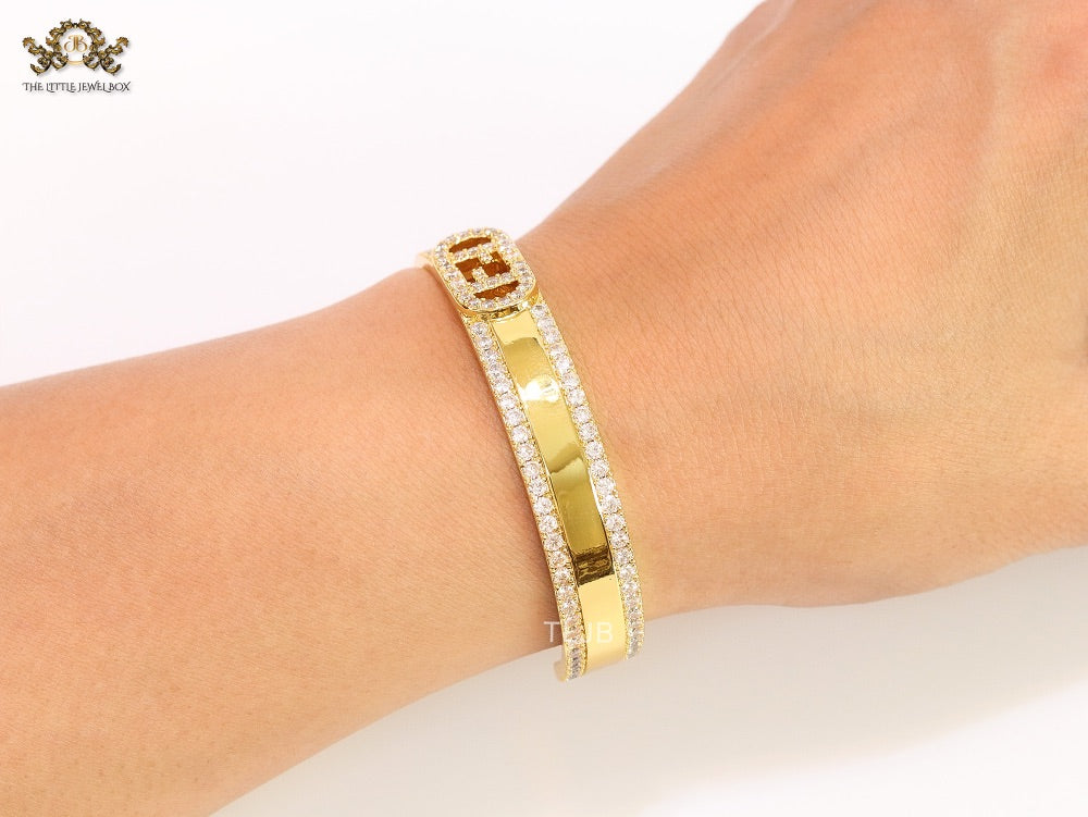 Double F on gold bracelet with cz