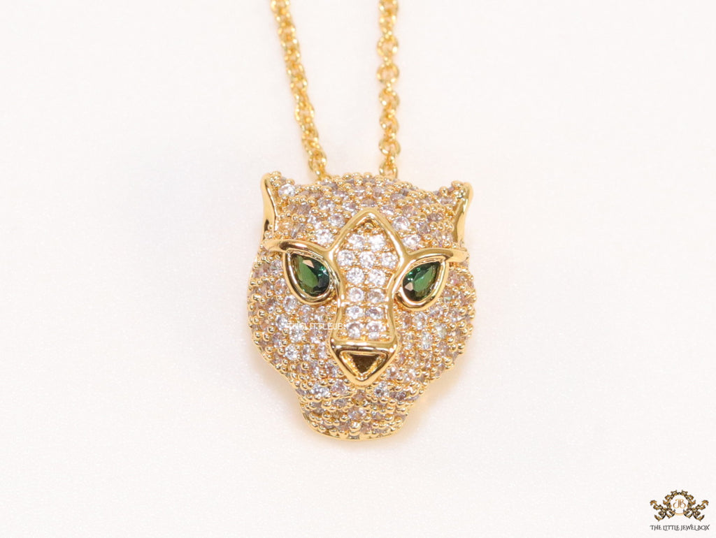 Gold plated cubic zirconia stones panther face motif pendant with emerald green stones details on sleek gold plated chain
