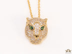 Gold plated cubic zirconia stones panther face motif pendant with emerald green stones details on sleek gold plated chain