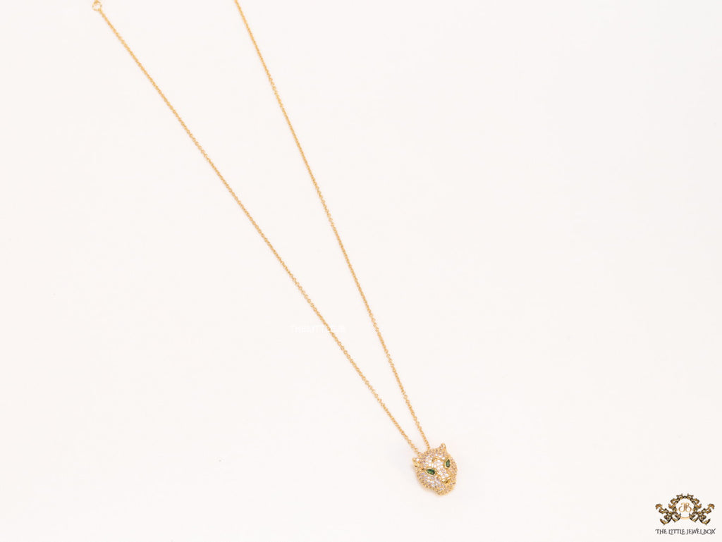 Gold plated cubic zirconia stones panther face motif pendant with emerald green stones details on sleek gold plated chain