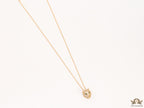Gold plated cubic zirconia stones panther face motif pendant with emerald green stones details on sleek gold plated chain