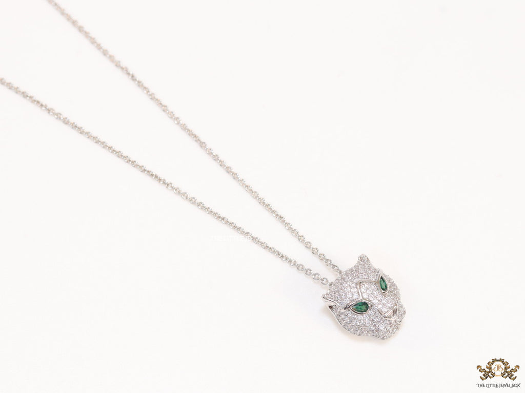 Platinum plated cubic zirconia stones panther face motif pendant with emerald green stones details on sleek Platinum plated chain