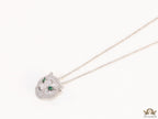 Platinum plated cubic zirconia stones panther face motif pendant with emerald green stones details on sleek Platinum plated chain