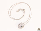 Platinum plated cubic zirconia stones panther face motif pendant with emerald green stones details on sleek Platinum plated chain
