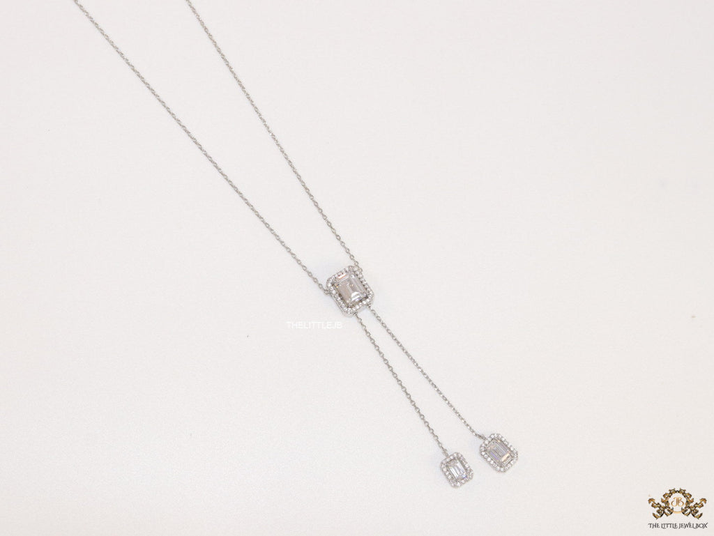 Emerald cut cubic zirconia stones in different sized on sleek platinum plated chain