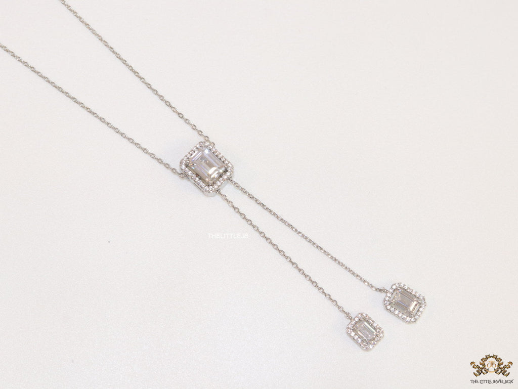 Emerald cut cubic zirconia stones in different sized on sleek platinum plated chain