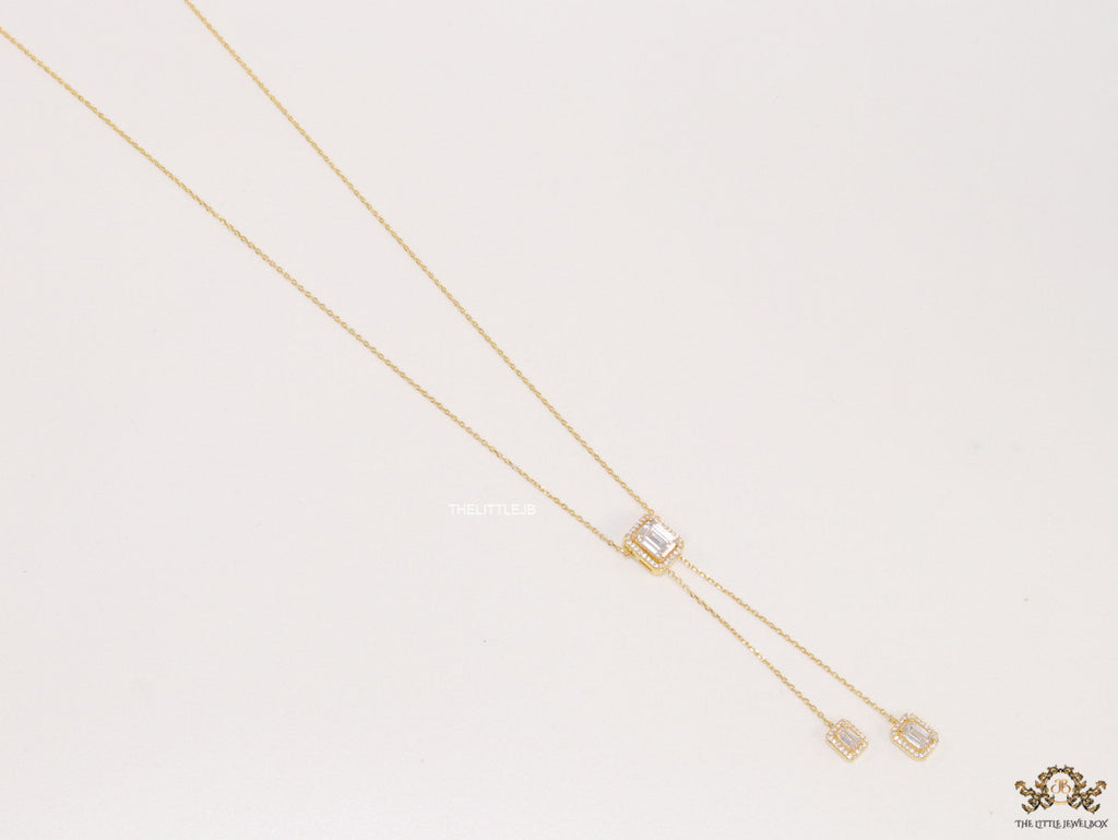 Emerald cut cubic zirconia stones in different sized on sleek gold plated chain