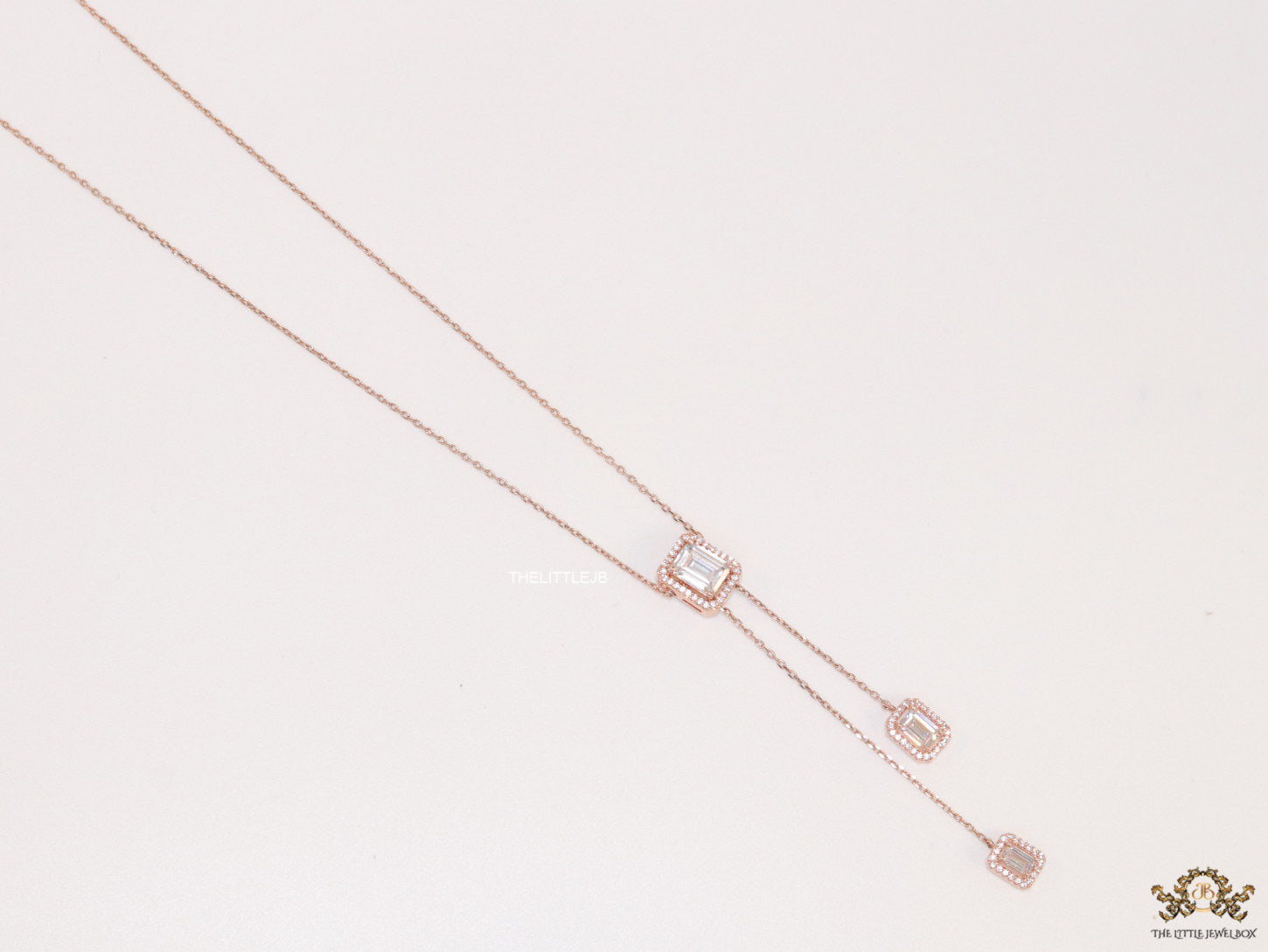 Emerald cut cubic zirconia stones in different sized on sleek rose gold plated chain